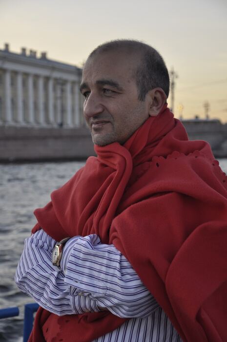 Cafer Tekin İpek, wearing a red cardigan.